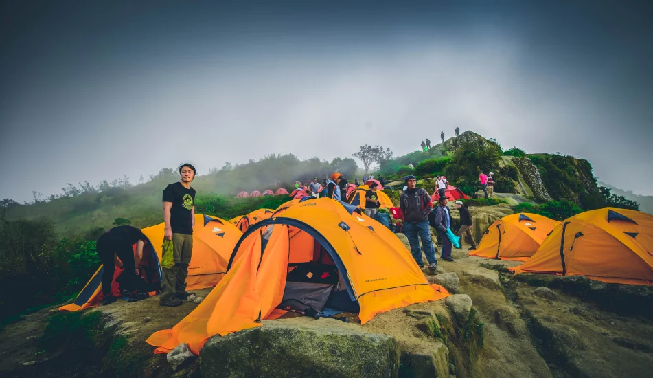 Inca Trail campsite with orange tents set along the ancient route to Machu Picchu in Peru