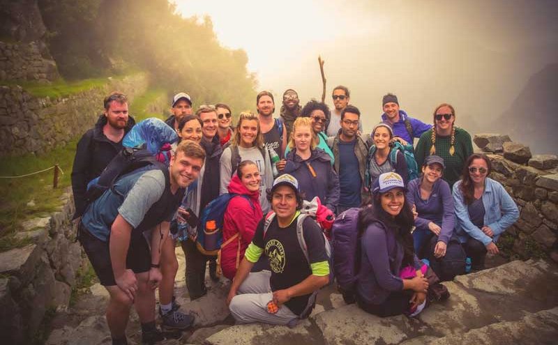Group of hikers on the Inca Trail to Machu Picchu enjoying the ancient stone path in Peru on the short inca trail