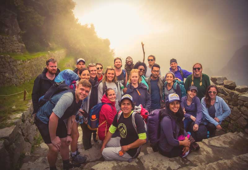 Group of hikers on the Inca Trail to Machu Picchu enjoying the ancient stone path in Peru on the short inca trail