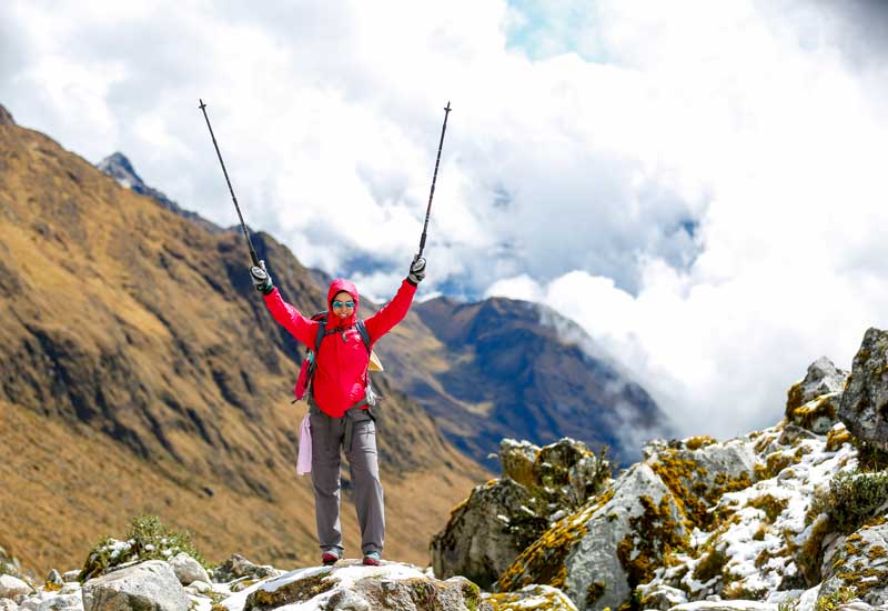 Hiker celebrating the Salkantay trekking route at high altitude