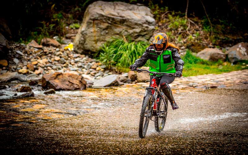 Mountain biking adventure on the Inca Jungle Trek crossing rivers and jungle trails in Peru
