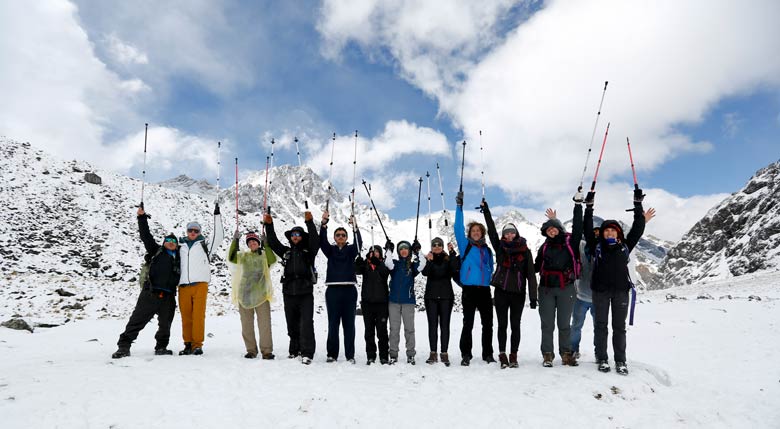 Hikers on the Salkantay Trek in Peru with snow-capped mountains in the background