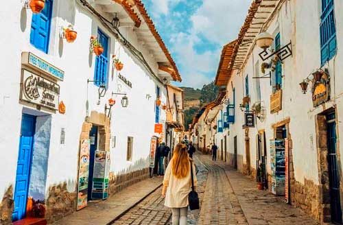 San Blas Street in Cusco with cobblestone paths, colonial houses, artisan workshops, and panoramic views of the historic city