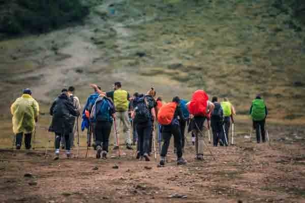 A group of hikers walks along a stunning mountain trail surrounded by snow-capped peaks. On the Salkantay route, every step is filled with adventure, breathtaking views, and a deep connection to the Andes.