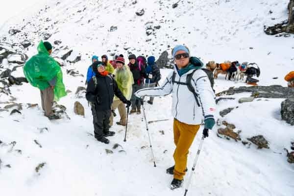 Snow-covered Salkantay Pass in the Andes with dramatic mountain peaks and trekkers crossing a high-altitude trail in Peru, Salkantay Trekking