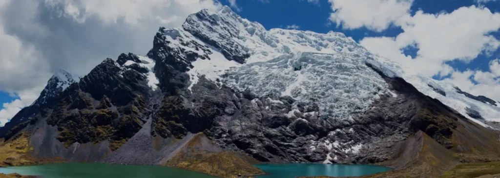 Ausangate Trek F.A.Q, Ausangate Trek in Peru with snowy mountains, high-altitude trails, and hikers in the Andes landscape near Cusco