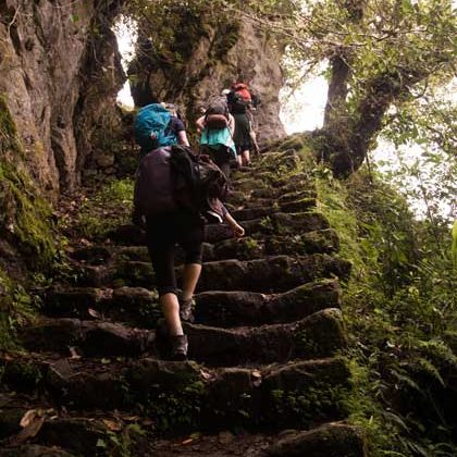 Hikers trekking along the Inca Trail in Peru with ancient stone pathways, mountain landscapes, and Inca archaeological sites