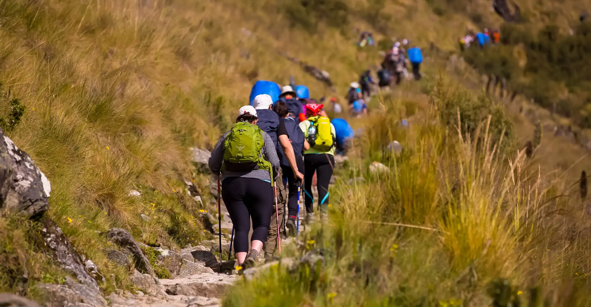 Inca Trail Route Highlands, Inca Trail highlands route in Peru with rugged Andean mountains, stone pathways, and hikers trekking through high-altitude landscape toward Machu Picchu, Inca Trail Permits, Inca Trail Vs Inca Jungle