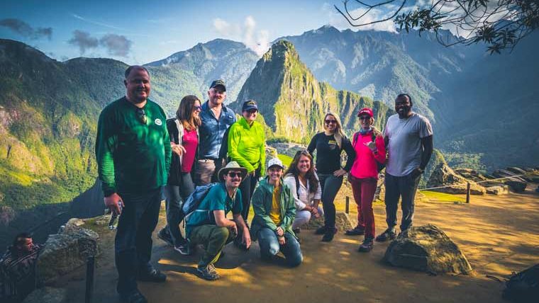 Machu Picchu Inca citadel in Peru with ancient stone ruins, terraces, and surrounding Andes mountains under clouds
