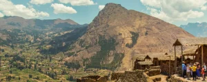 Pisac Travel Guide in the Sacred Valley, Pisac Sacred Valley Peru with Inca terraces, archaeological ruins on the mountainside, and Urubamba River valley landscape
