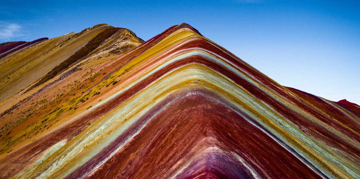 Rainbow Mountain Tour Cusco, Rainbow Mountain Vinicunca in Peru with vibrant colorful slopes, snow-capped Andes peaks, and tourists hiking at high altitude