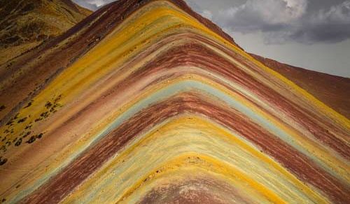 Rainbow Mountain Cusco, Rainbow Mountain Vinicunca in Peru with colorful striped slopes, snow-capped peaks, and tourists hiking at high altitude in the Andes