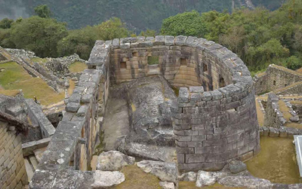 Temple of the Sun in Machu Picchu Peru with curved stone structure, Inca ruins, and panoramic Andes mountain views