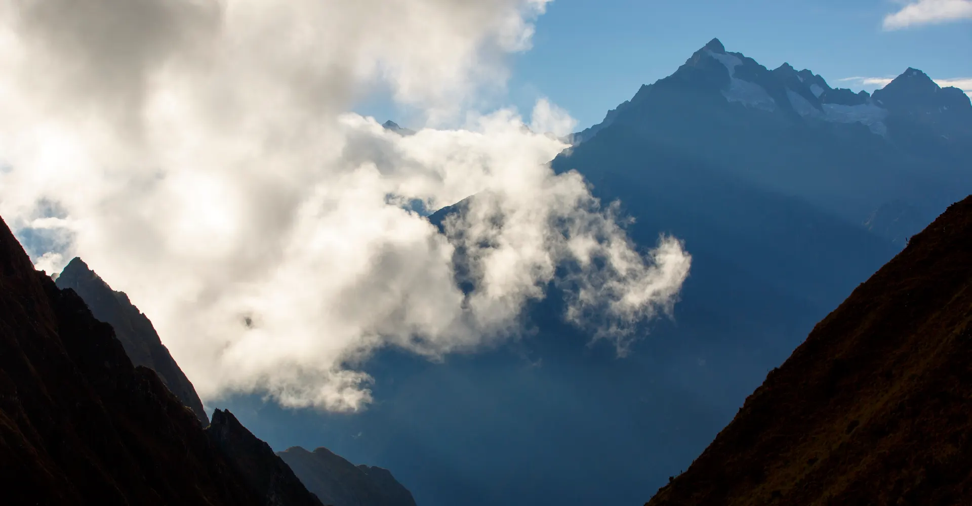 inca trail inclusions, Inca Trail trekking group in Peru with guide, camping equipment, porters, and mountain trail leading through Andes toward Machu Picchu