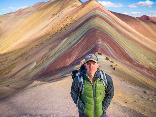 Peru: 11 Days Trek,Panoramic view of Vinicunca Rainbow Mountain in Cusco, Peru, showcasing its colorful mineral-striped slopes