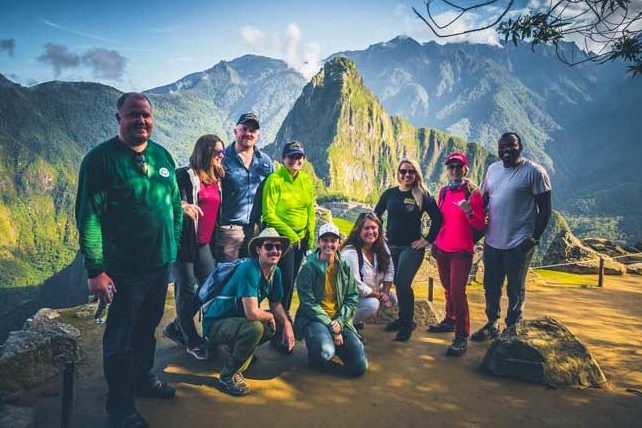 Machu Picchu Inca citadel in Peru with ancient stone ruins, terraces, and surrounding Andes mountains under clouds