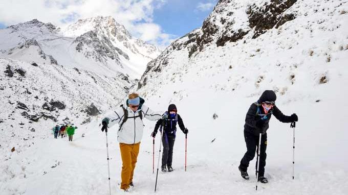 Hikers trekking through snowy mountains: Mount Salkantay and Humantay Lake